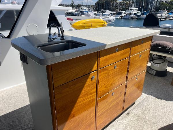Slide: The Image of Outdoor sink and storage unit on a 1986 Hatteras 70' Cockpit Motor Yacht. - 31