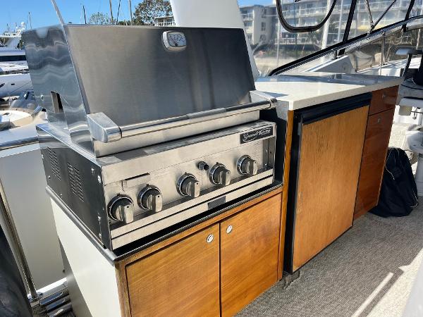 Slide: The Image of Outdoor kitchen on 1986 Hatteras 70' Cockpit Motor Yacht with stainless steel grill. - 32
