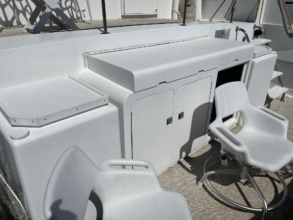 Slide: The Image of 1986 Hatteras 70' Cockpit Motor Yacht deck with seating and storage. - 38