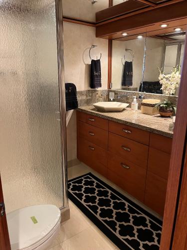 Slide: The Image of Luxurious bathroom in a 1986 Hatteras 70' Cockpit Motor Yacht with modern fixtures. - 43