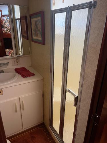 Slide: The Image of Bathroom interior of a 1986 Hatteras 70' Cockpit Motor Yacht with shower and sink. - 46