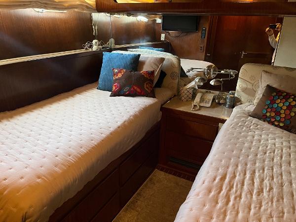 Slide: The Image of Interior cabin of 1986 Hatteras 70' Cockpit Motor Yacht with twin beds and cozy decor. - 6