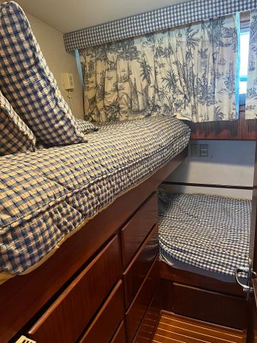 Slide: The Image of Bunk beds in the 1986 Hatteras 70' Cockpit Motor Yacht cabin with checkered bedding. - 7