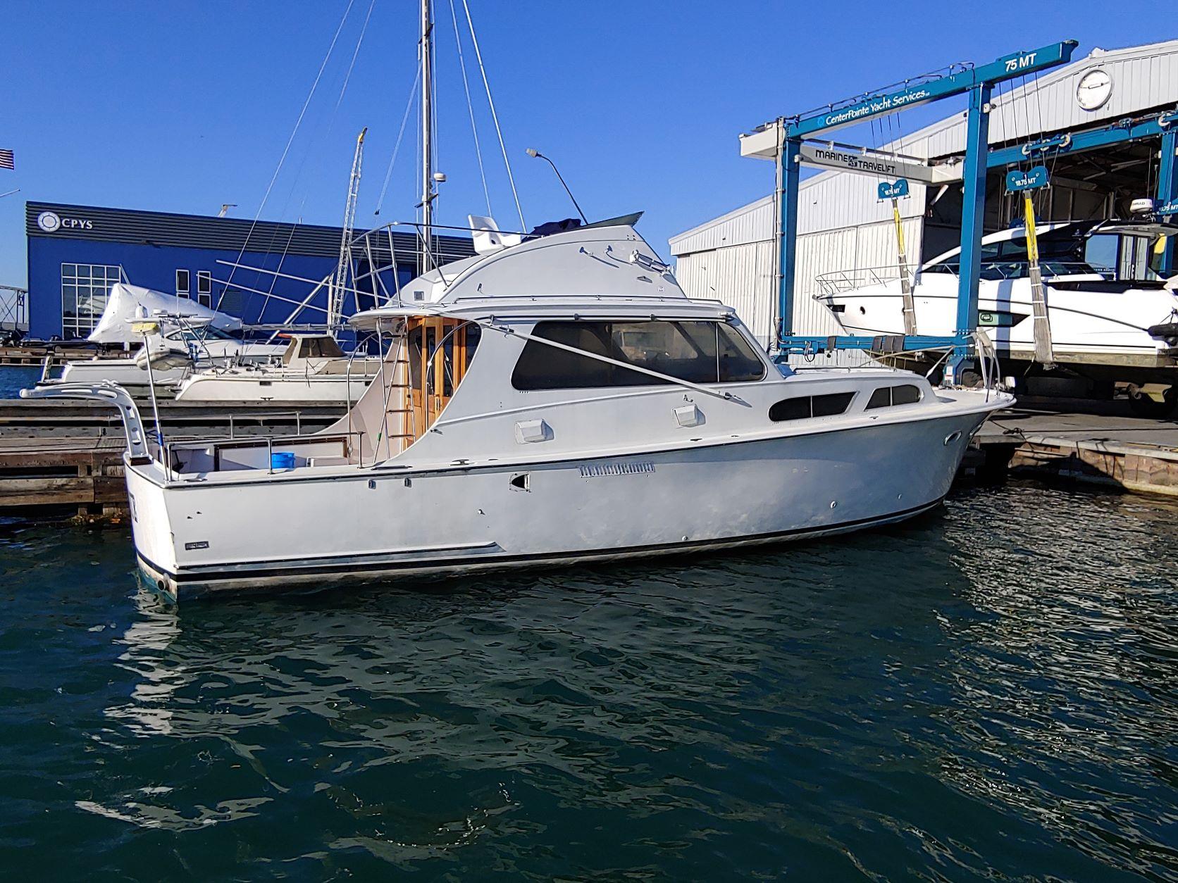 Slide: The Image of 1961 Hatteras Convertible yacht docked at a marina. - 1