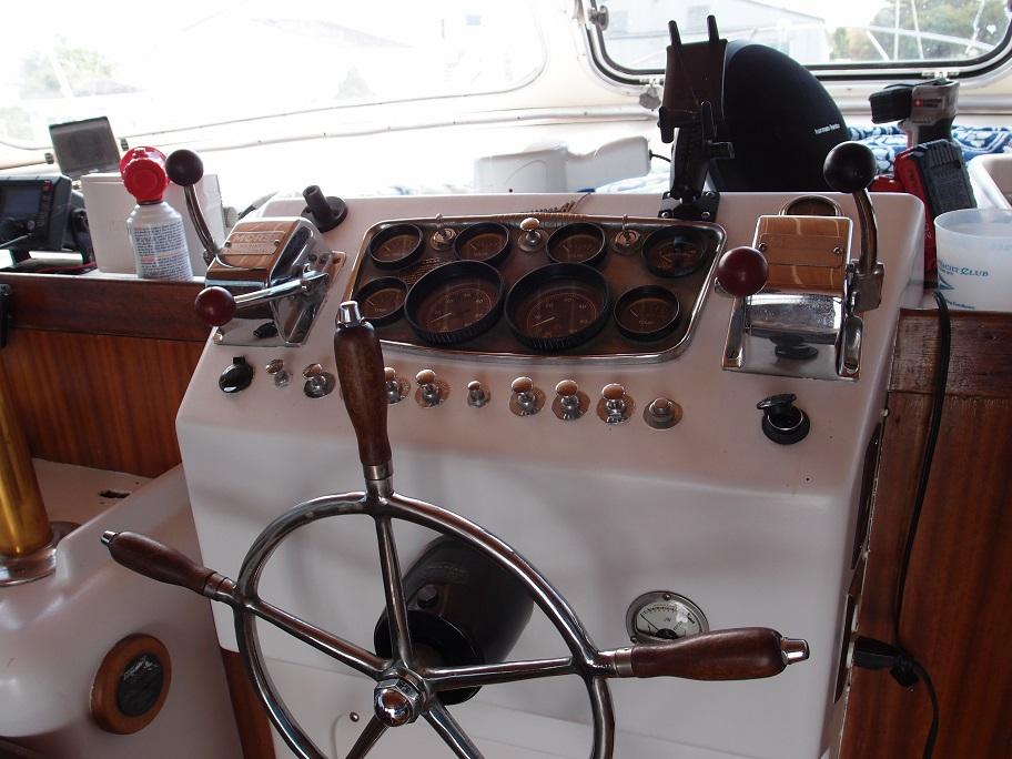 Slide: The Image of 1961 Hatteras Convertible boat helm with vintage gauges and wooden steering wheel. - 12