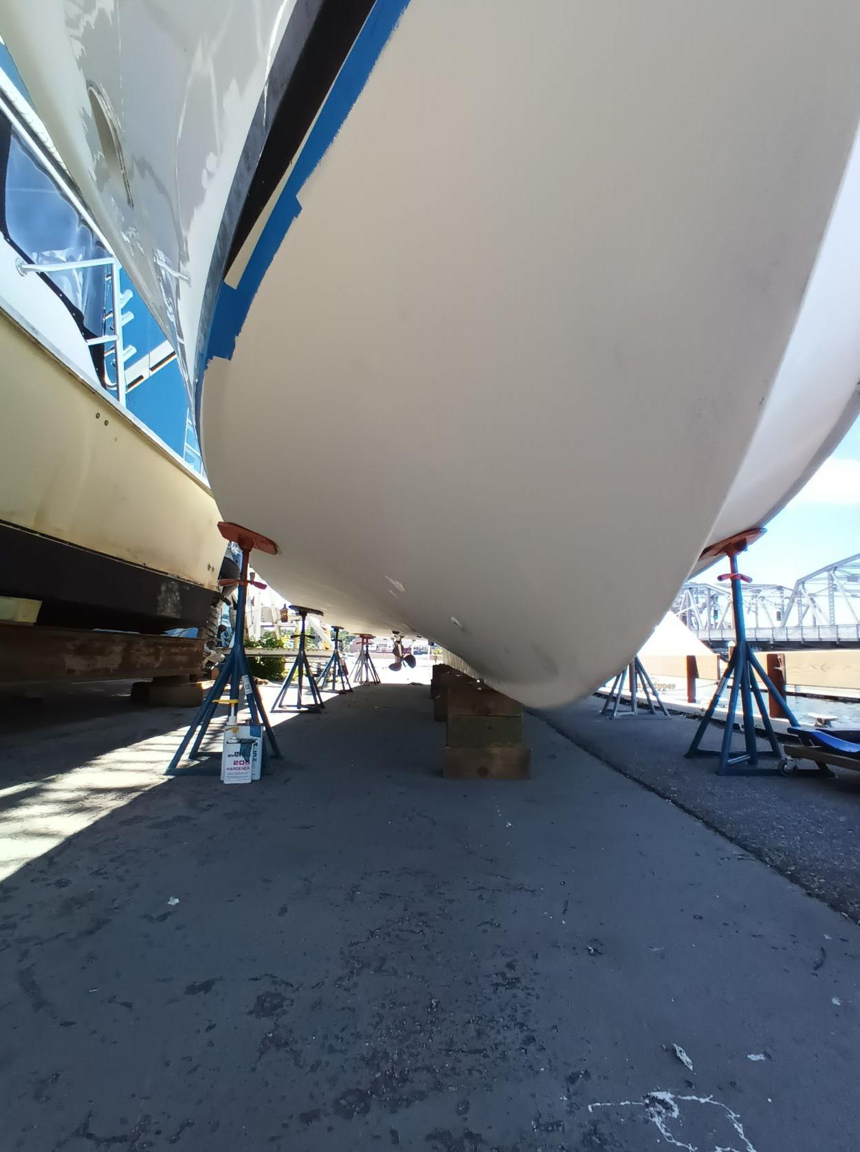 Slide: The Image of 1961 Hatteras Convertible boat on stands for maintenance. - 2