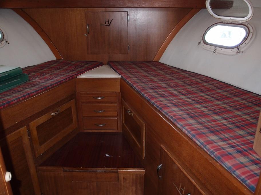 Slide: The Image of Interior cabin of a 1961 Hatteras Convertible boat with twin beds and wooden cabinetry. - 20