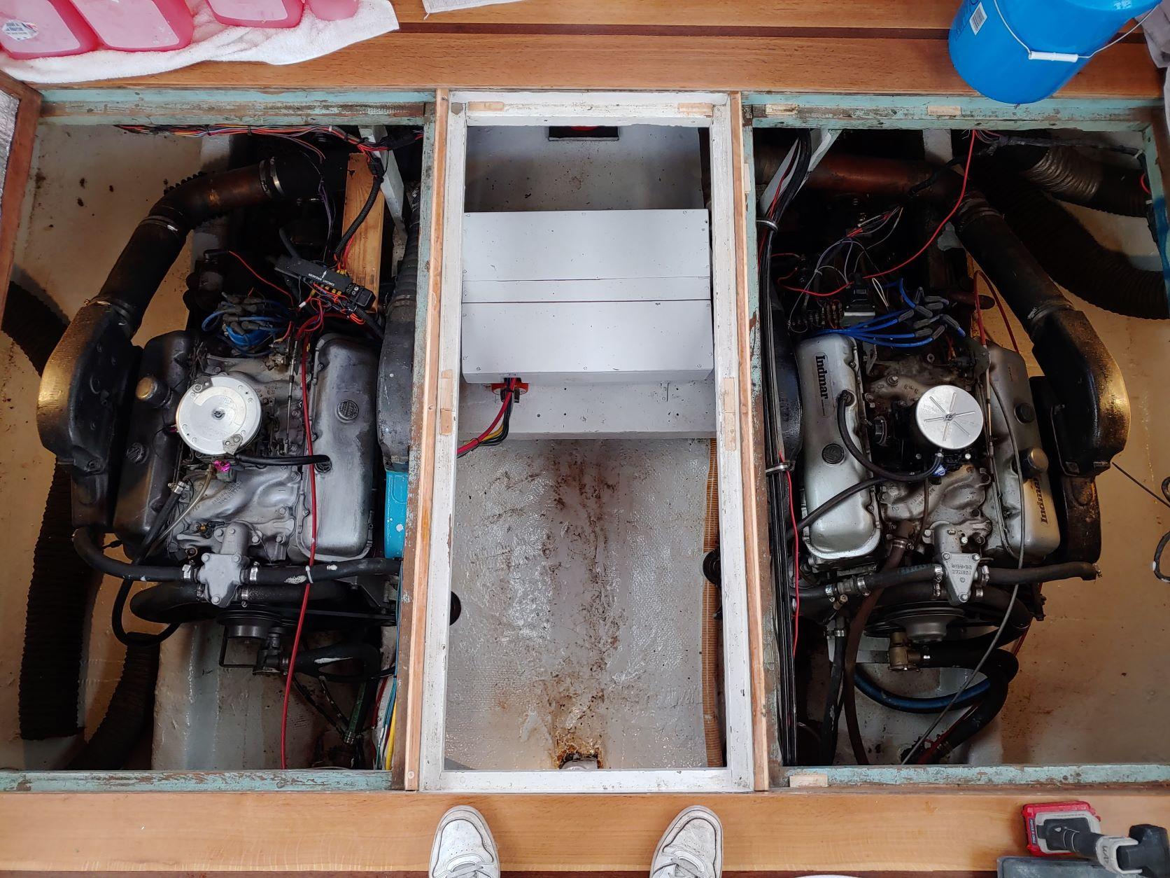 Slide: The Image of 1961 Hatteras Convertible engine compartment with twin engines and wiring. - 22