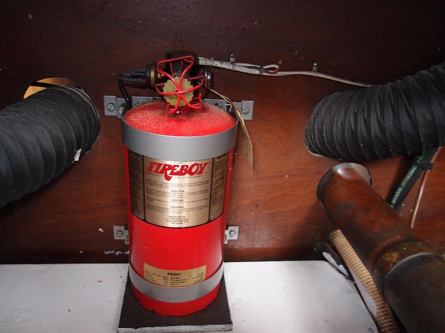 Slide: The Image of Fire extinguisher in the engine room of a 1961 Hatteras Convertible boat. - 24