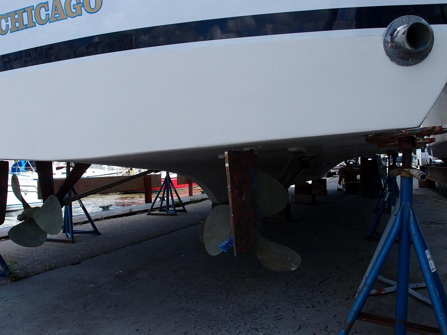 Slide: The Image of 1961 Hatteras Convertible boat on stands, showing propellers and hull. - 30