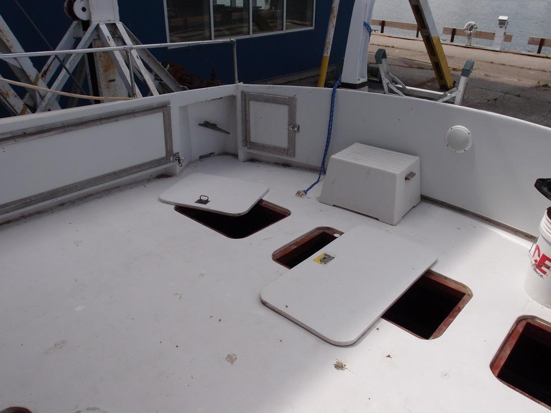 Slide: The Image of 1961 Hatteras Convertible boat deck with open storage compartments. - 6