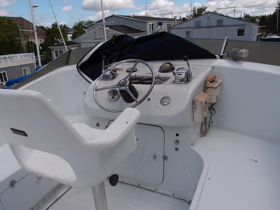 Slide: The Image of 1961 Hatteras Convertible boat helm with steering wheel and controls. - 8