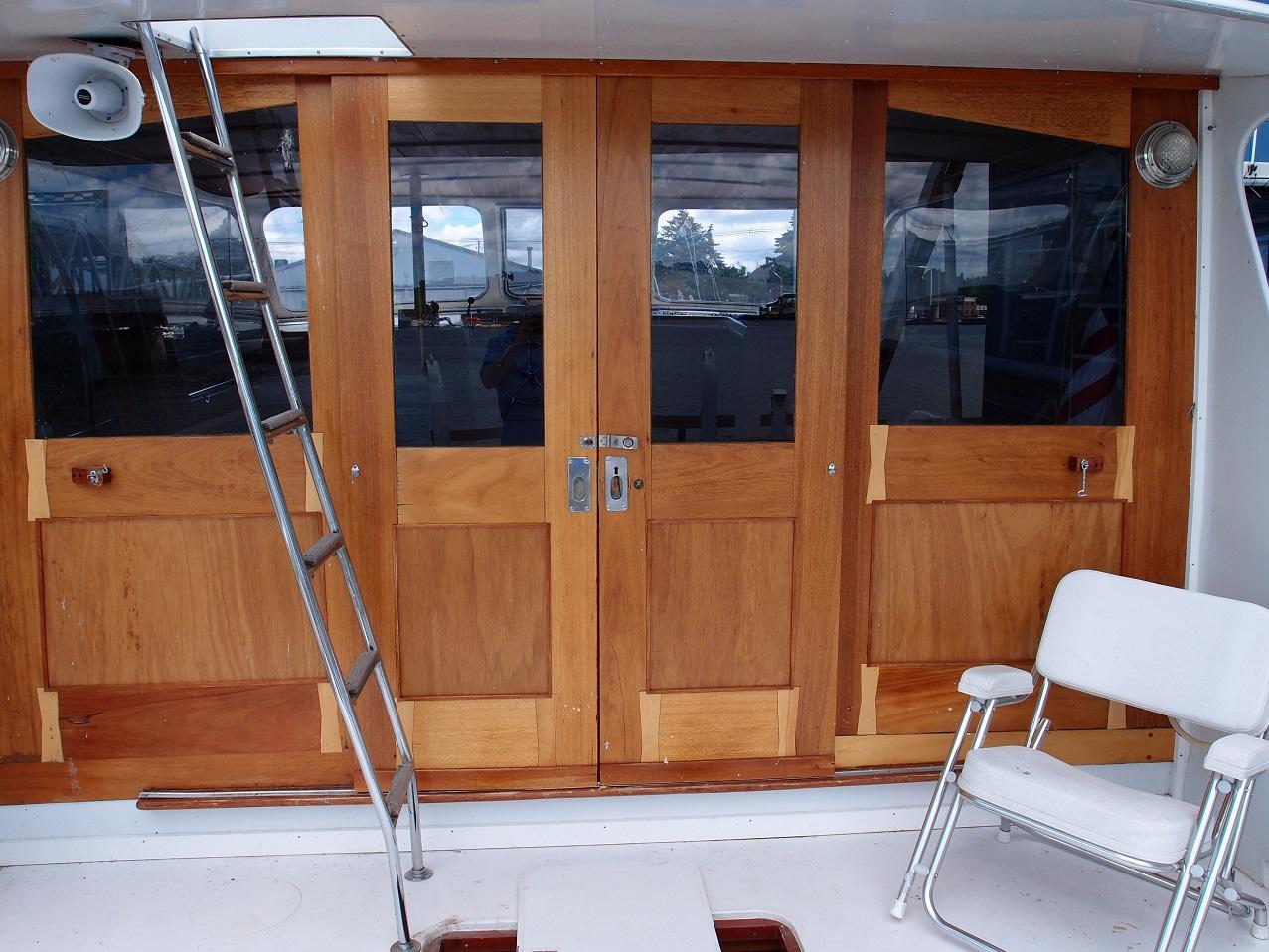 Slide: The Image of 1961 Hatteras Convertible boat with wooden doors and a metal ladder. - 9