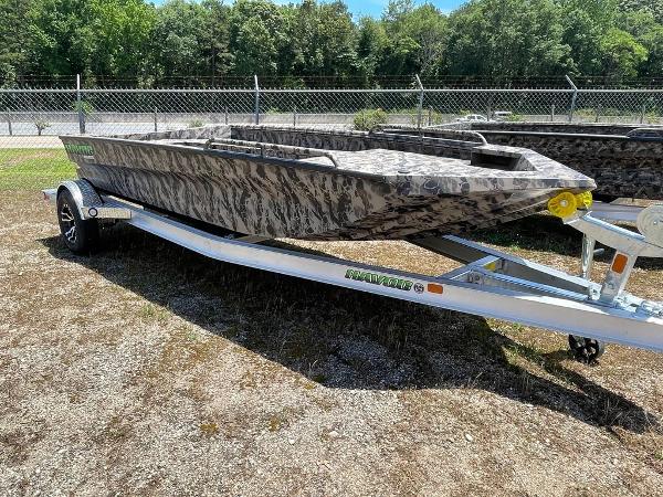 Slide: The Image of 2022 Havoc 1860 Dbst boat on trailer, camo design, parked outdoors. - 1
