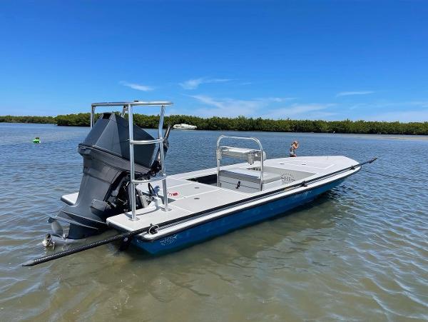 Slide: The Image of 2009 Hell's Bay WATERMAN boat in shallow water, clear sky background. - 1