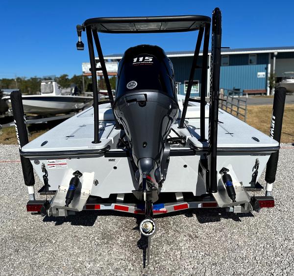 Slide: The Image of 2024 Hewes 18 Redfisher boat with 115 HP outboard motor, rear view. - 2