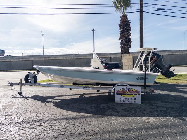 Slide: The Image of 2024 Hewes Redfisher 18 boat on trailer, parked outdoors. - 1