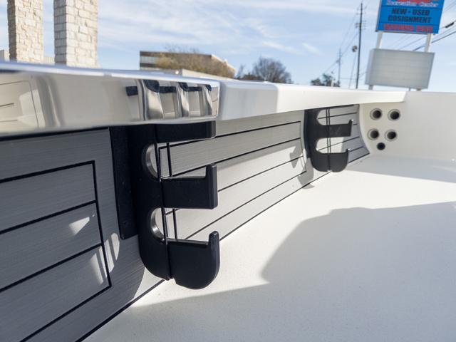 Slide: The Image of 2024 Hewes Redfisher 18 boat interior detail with rod holders and sleek design. - 22
