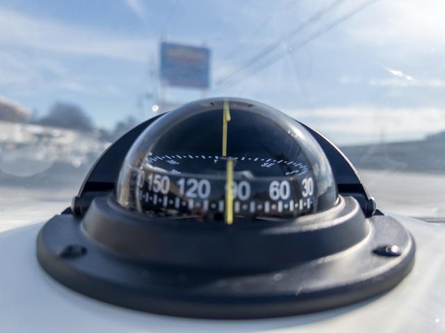Slide: The Image of Close-up of a compass on a 2024 Hewes Redfisher 18 boat. - 27