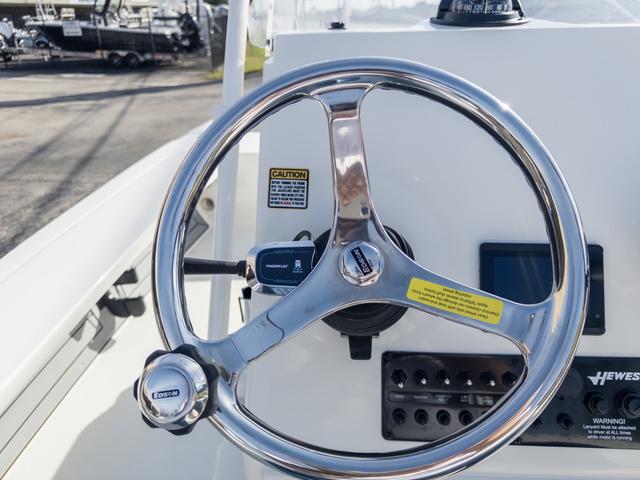 Slide: The Image of 2024 Hewes Redfisher 18 boat steering wheel and dashboard controls. - 28