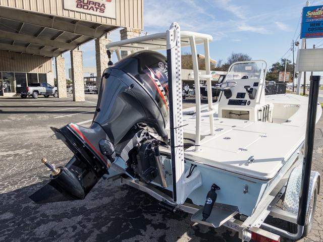 Slide: The Image of 2024 Hewes Redfisher 18 boat with outboard motor at dealership. - 8