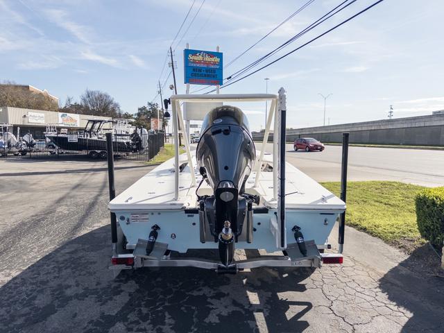 Slide: The Image of 2024 Hewes Redfisher 18 boat on trailer, rear view, parked outdoors. - 9