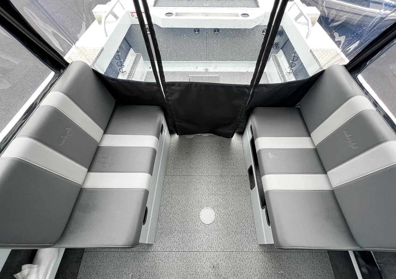 Slide: The Image of Interior seating of 2023 Hewescraft 190 Sea Runner boat with gray and white upholstery. - 12