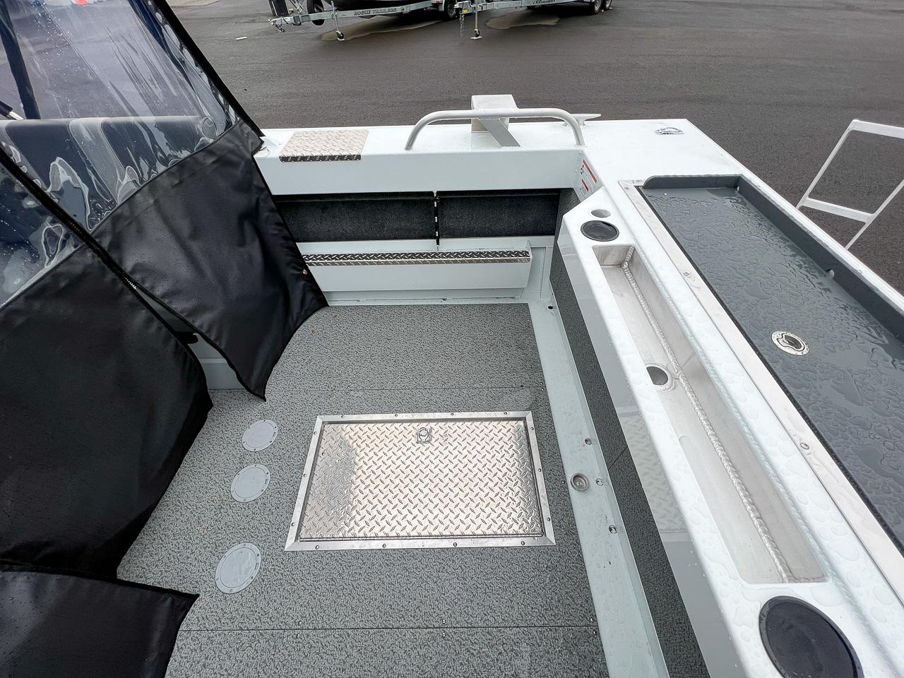 Slide: The Image of 2023 Hewescraft 190 Sea Runner boat interior with storage compartments and seating area. - 15