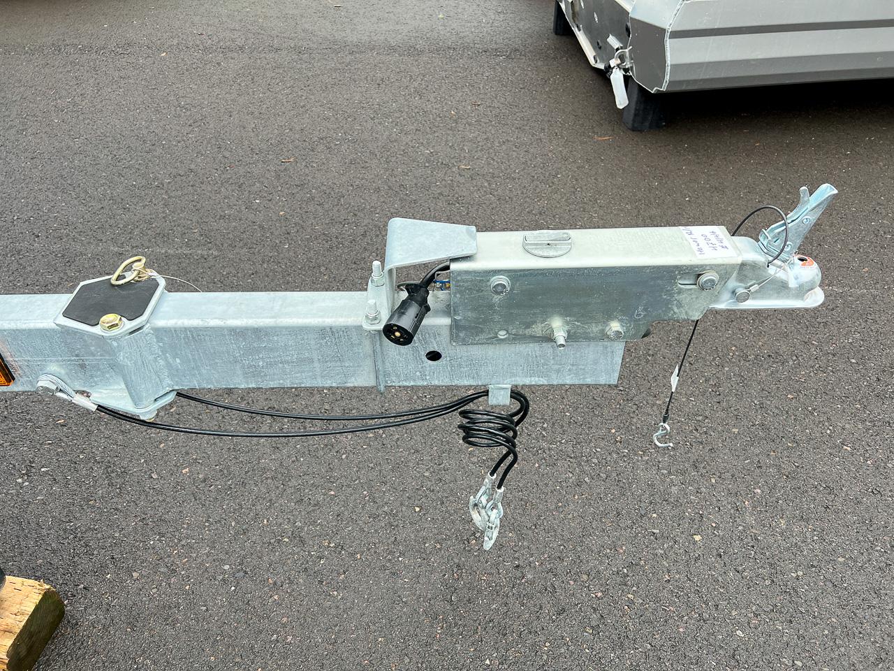 Slide: The Image of Close-up of a 2023 Hewescraft 190 Sea Runner trailer hitch on asphalt. - 17