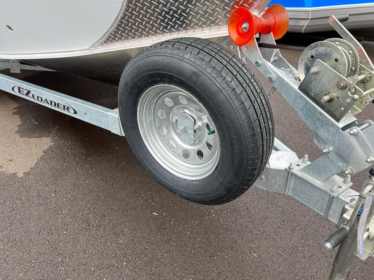 Slide: The Image of 2023 Hewescraft 190 Sea Runner on EZ Loader trailer, close-up of wheel and hitch. - 18