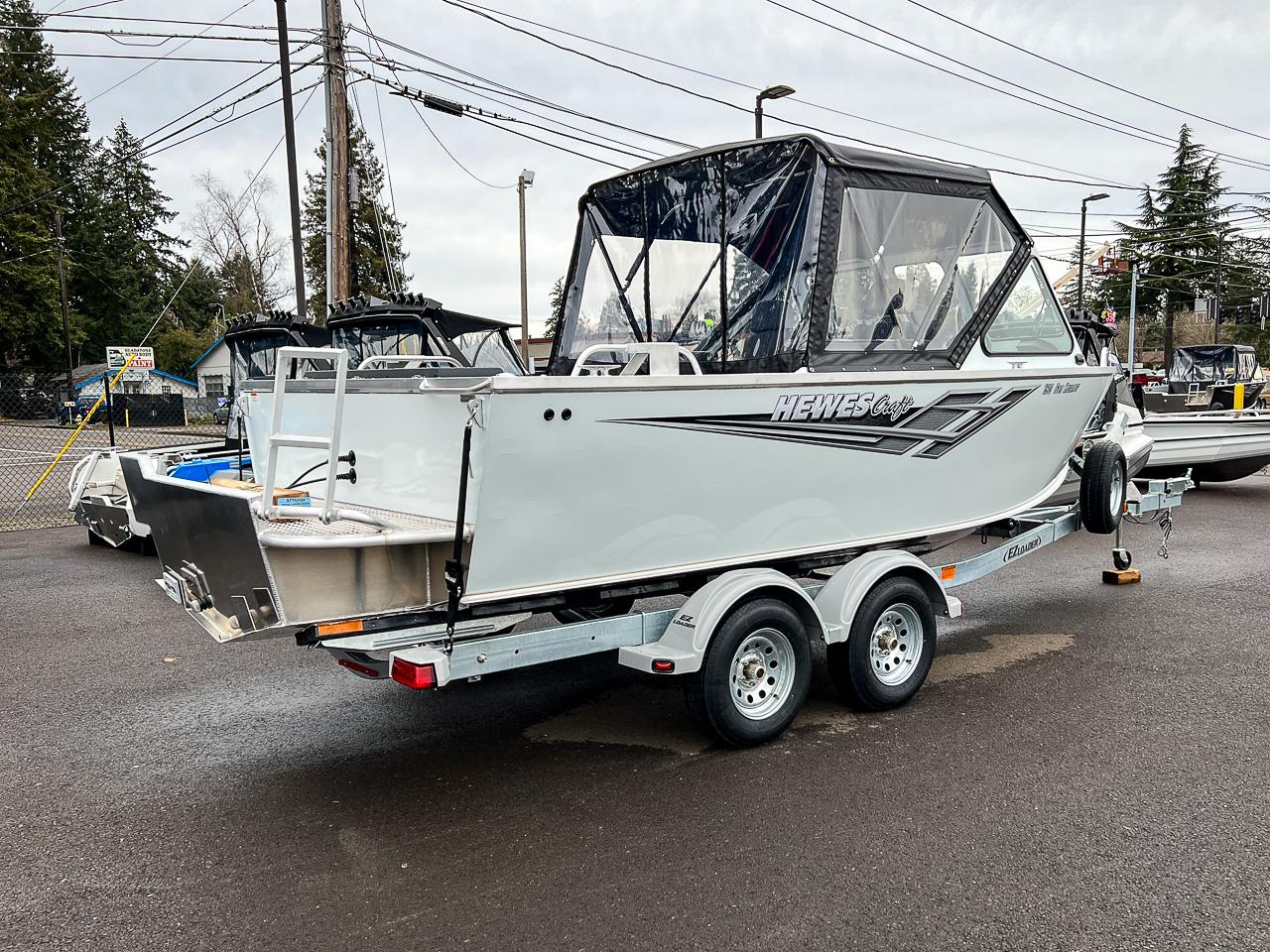 Slide: The Image of 2023 Hewescraft 190 Sea Runner boat on a trailer in a parking lot. - 3