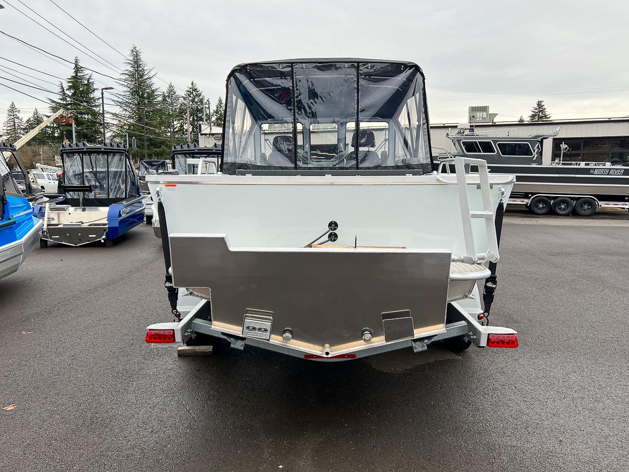 Slide: The Image of 2023 Hewescraft 190 Sea Runner boat, rear view, in a boatyard. - 4