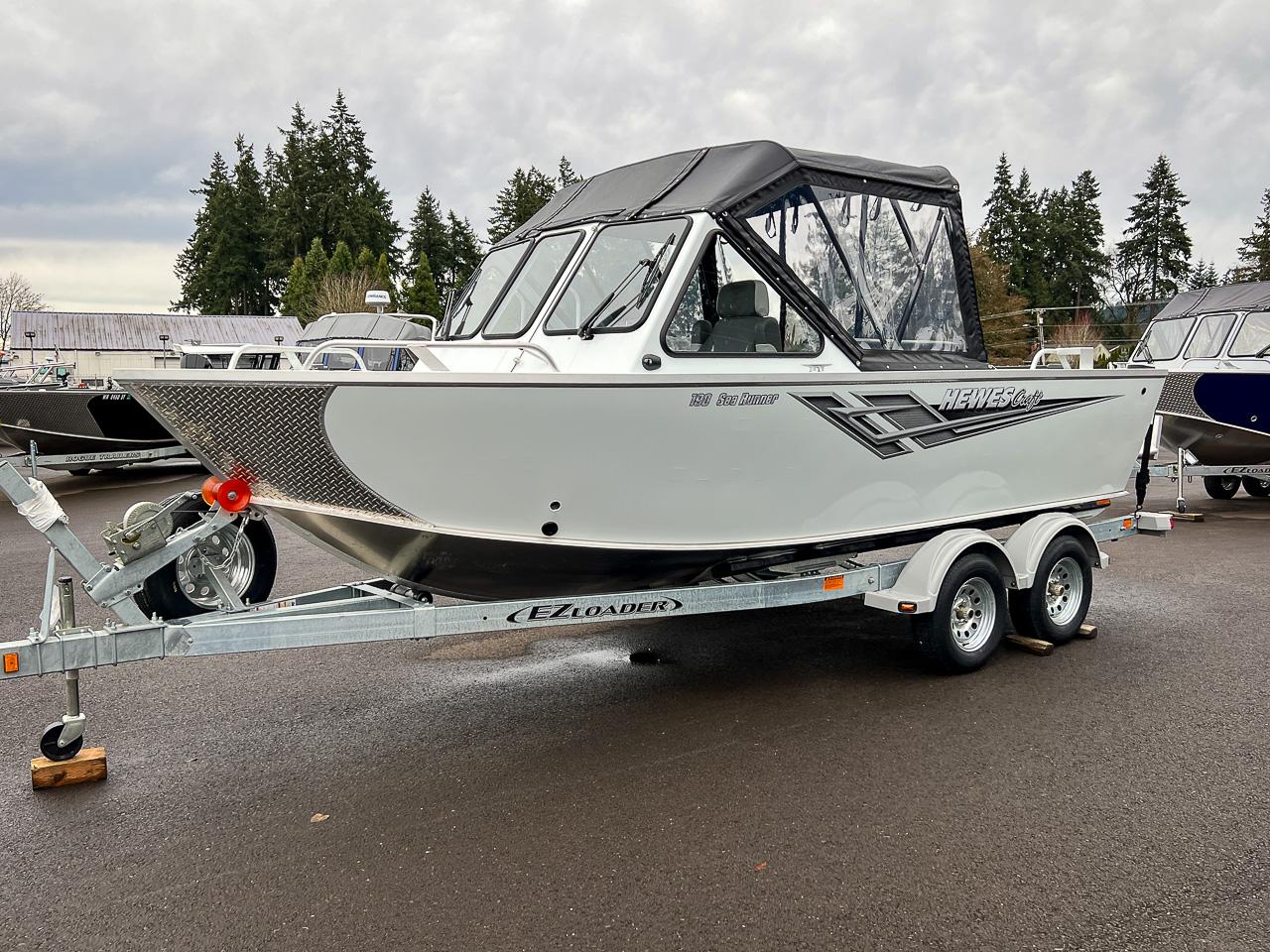 Slide: The Image of 2023 Hewescraft 190 Sea Runner boat on trailer, parked outdoors. - 6