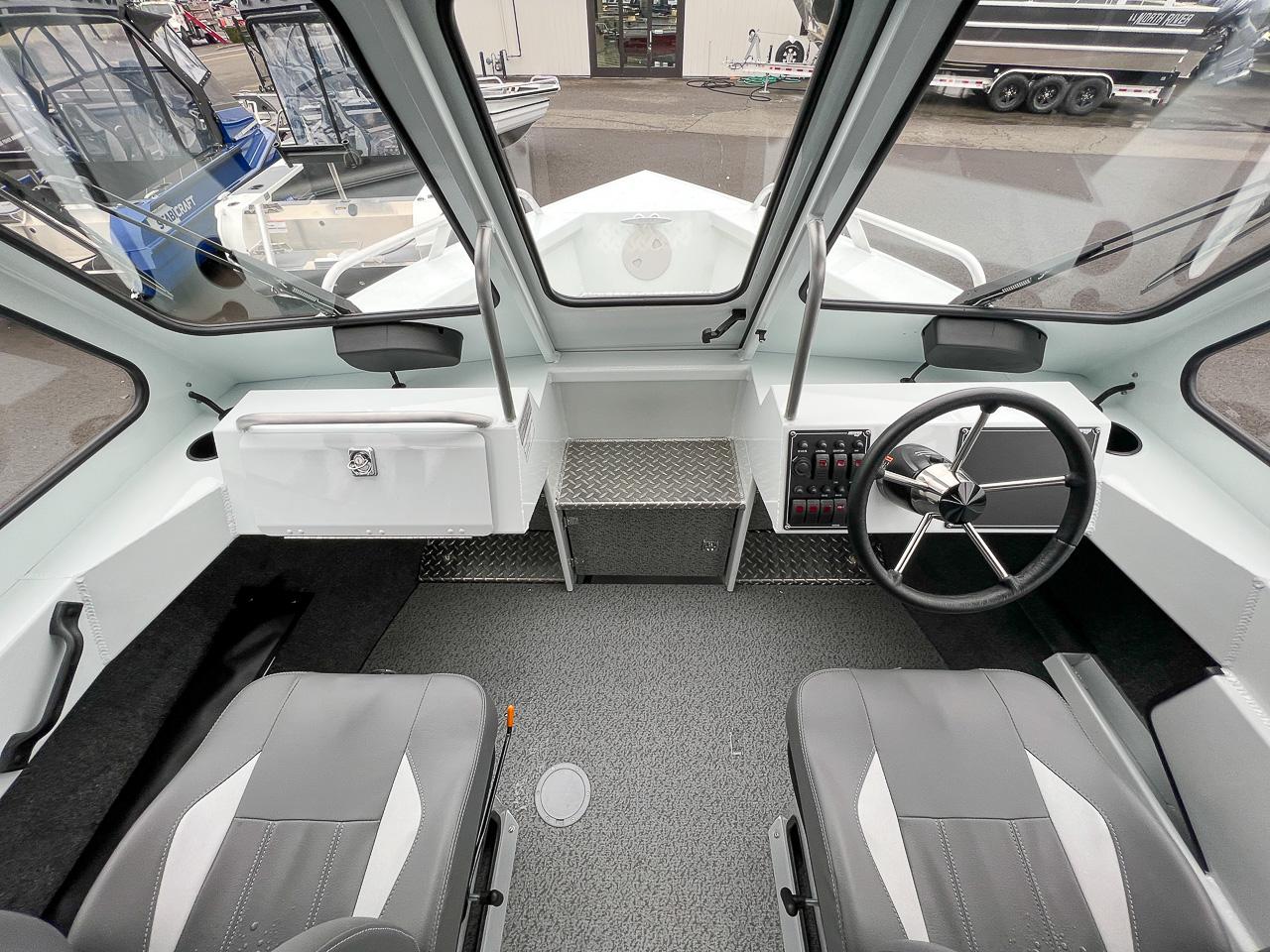 Slide: The Image of 2023 Hewescraft 190 Sea Runner interior cockpit with steering wheel and seating. - 9