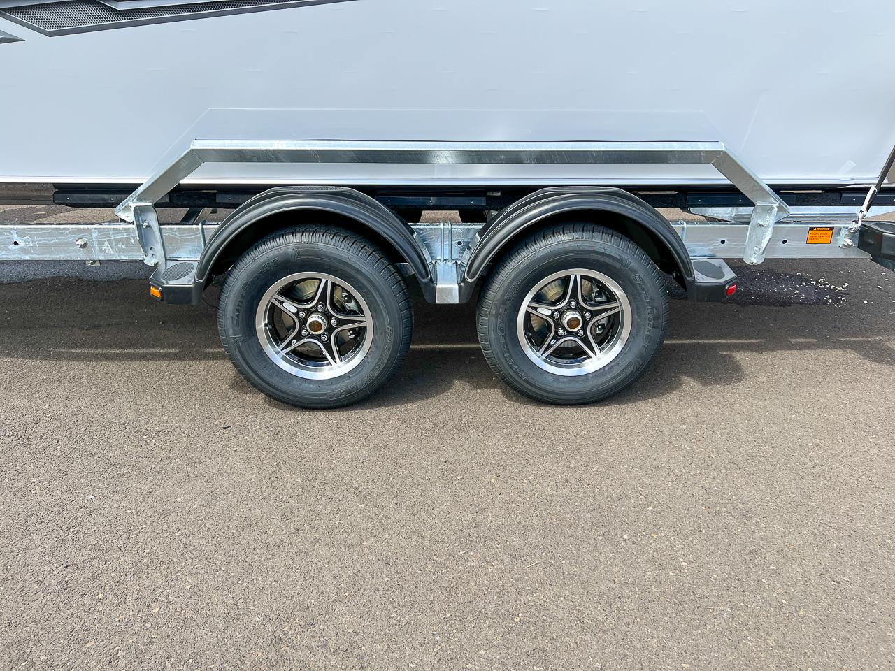 Slide: The Image of 2023 Hewescraft 200 Pro-V ET HT trailer with dual wheels on asphalt. - 18