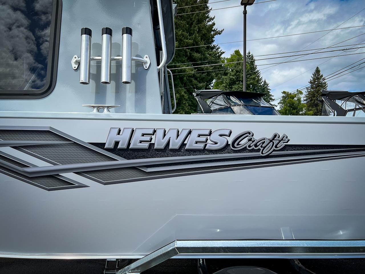 Slide: The Image of 2023 Hewescraft 200 Pro-V ET HT boat side view with logo and rod holders. - 19
