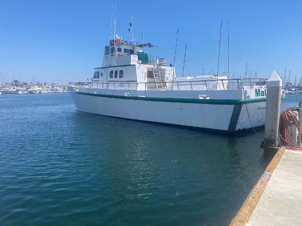 Slide: The Image of 1945 Higgins PT boat docked at a marina on a sunny day. - 1