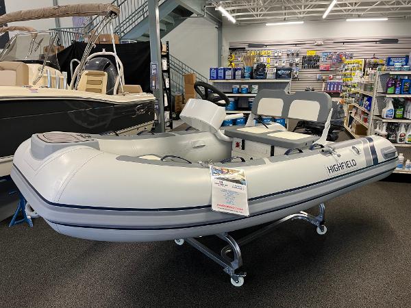 Slide: The Image of 2024 Highfield Classic 310 inflatable boat displayed in a showroom. - 1
