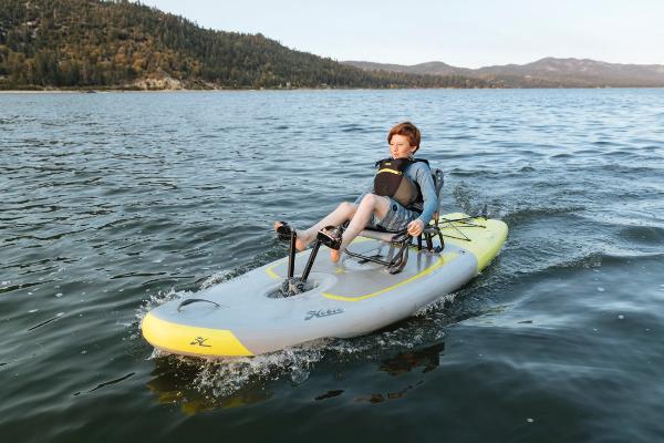 Slide: The Image of Person kayaking on a 2023 Hobie iTrek 9 Ultralight in a scenic lake. - 0