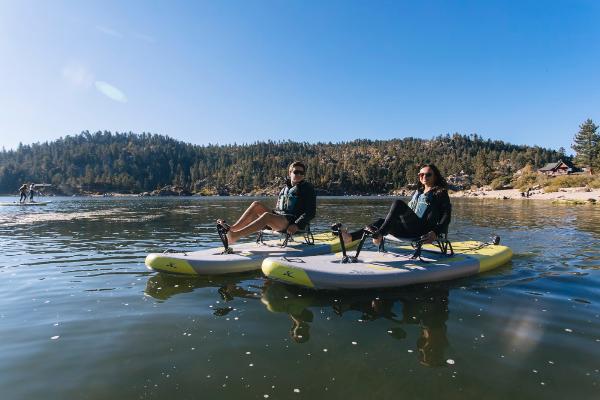 Slide: The Image of Two people on Hobie iTrek 9 Ultralight kayaks, 2023 model, on a serene lake. - 4