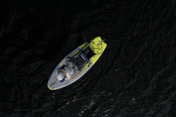 Slide: The Image of Aerial view of a 2023 Hobie iTrek 9 Ultralight kayak on dark water. - 9