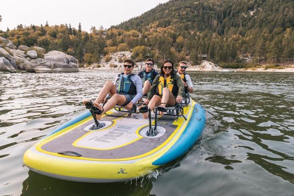 Slide: The Image of Four people enjoying a ride on a 2023 Hobie iTrek Fiesta pedal kayak. - 0