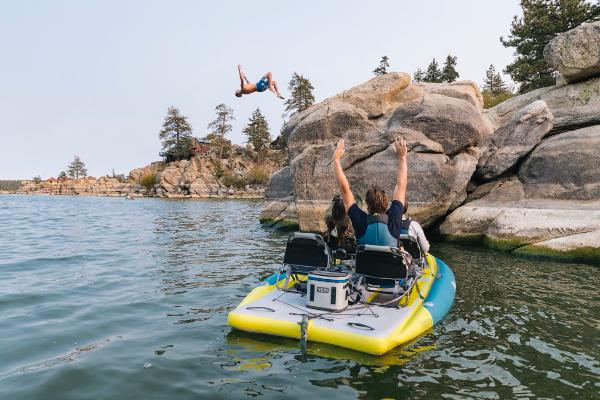 Slide: The Image of 2023 Hobie iTrek Fiesta on lake, people enjoying water activities near rocky shore. - 4