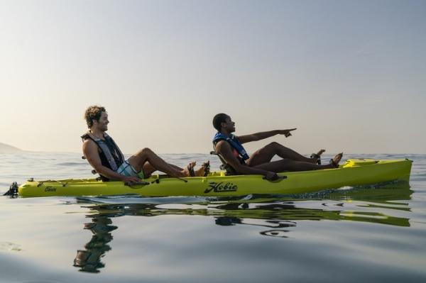 Slide: The Image of Two people kayaking on a 2022 Hobie Mirage Oasis in calm waters. - 0