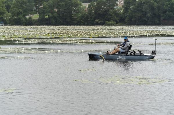 Slide: The Image of Man fishing on a 2023 Hobie Mirage Pro Angler 12 kayak with 360 Drive Technology. - 2