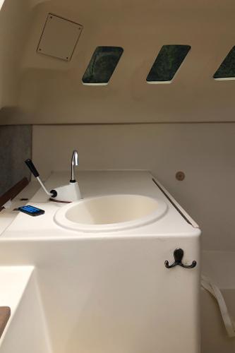 Slide: The Image of Interior of a 1998 Hunter 240 sailboat with sink and windows. - 13