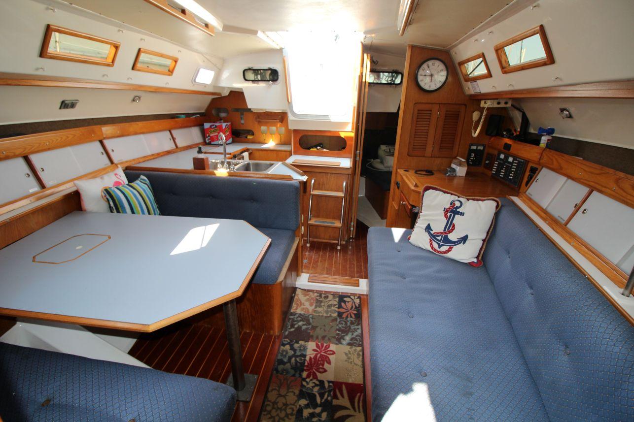 Slide: The Image of Interior of a 1987 Hunter 34 sailboat with cozy seating and nautical decor. - 16