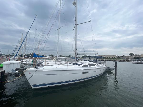 Slide: The Image of Sailboat docked in marina, Hunter 410 model, year 2000, under cloudy sky. - 1