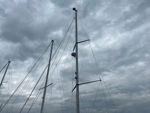 Slide: The Image of Masts of a 2000 Hunter 410 sailboat against a cloudy sky. - 14