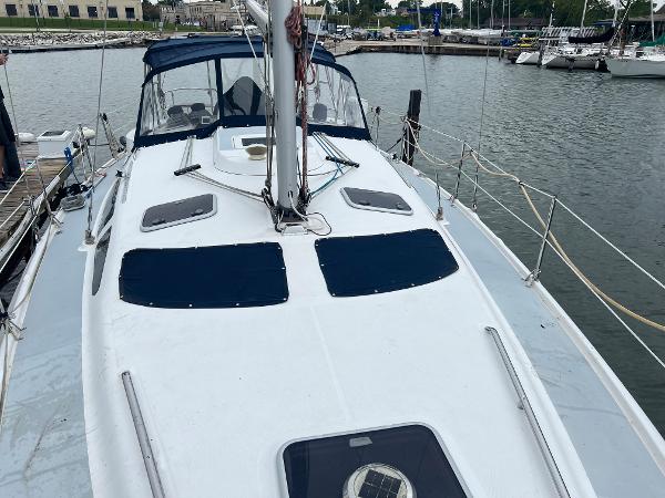 Slide: The Image of Sailboat Hunter 410, 2000 model, docked at marina with blue canopy and sleek design. - 17